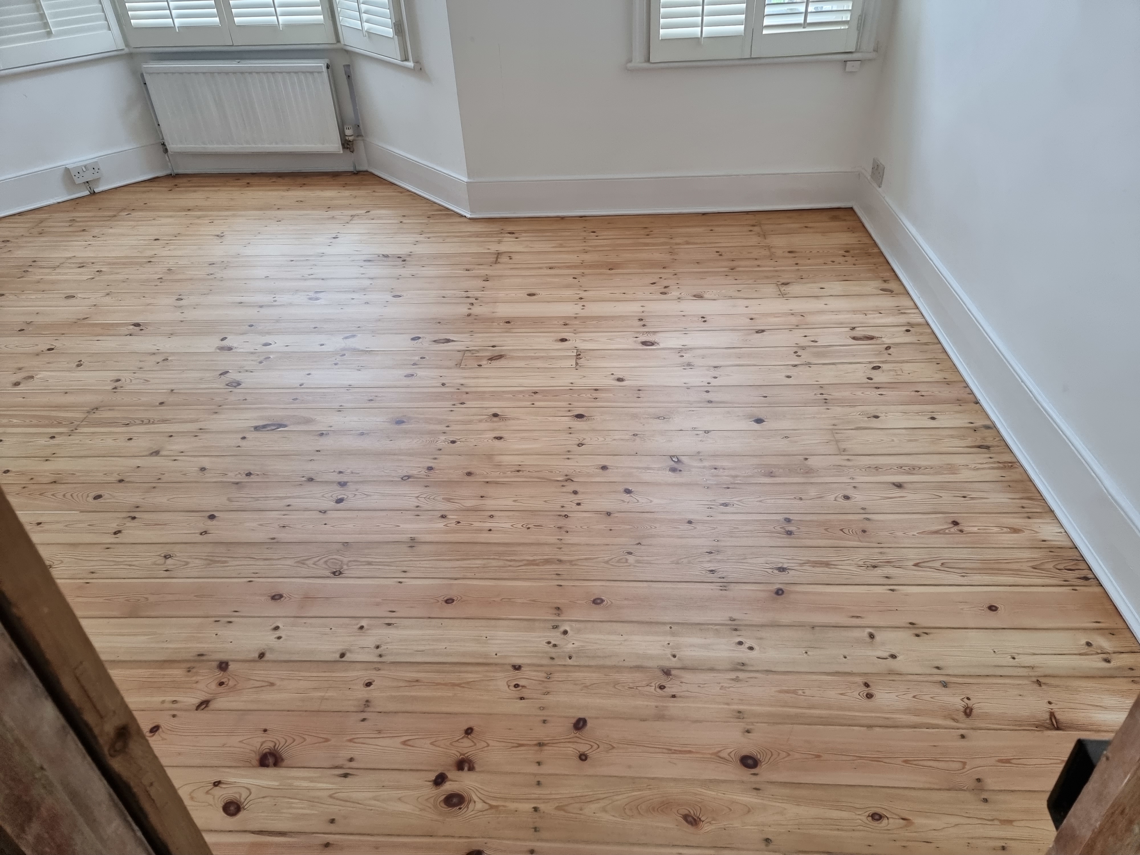 Floorboards floor after sanding work in SW18